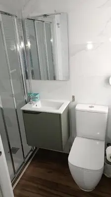 a bathroom with a toilet and a sink and a shower at La mesa del cocinero in Lugo