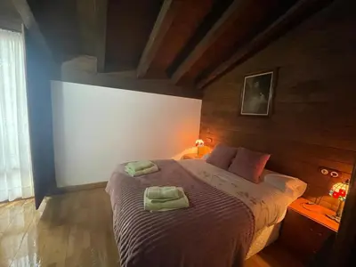 a bedroom with a bed with two towels on it at Apartamentos Torre Villar in Villar de Vildas