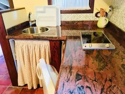 a kitchen with a counter top with a sink at Apartamentos Torre Villar in Villar de Vildas