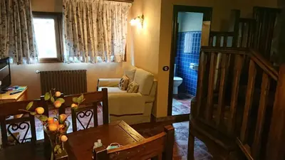 a living room with a dining table and a living room at Apartamentos Torre Villar in Villar de Vildas