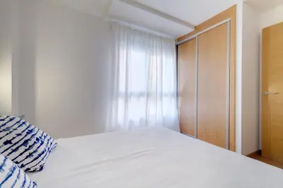 a bedroom with a white bed and a window at Duerming Family Viveiro 4 Rooms in Viveiro