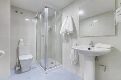 a bathroom with a shower and a sink and a toilet at Duerming Family Viveiro 4 Rooms in Viveiro