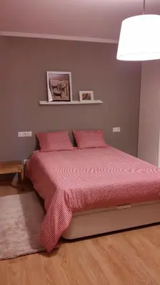 a bedroom with a bed with red sheets and a lamp at Apartamento con piscina en Foz in Foz