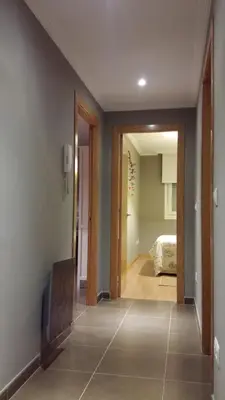 a hallway with a door leading to a bedroom at Apartamento con piscina en Foz in Foz