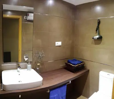 a bathroom with a sink and a toilet at Apartamento con piscina en Foz in Foz