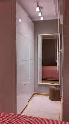 a bedroom with a mirror and a red bed at Apartamento con piscina en Foz in Foz
