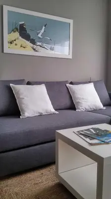 a living room with a couch and a coffee table at Apartamento con piscina en Foz in Foz
