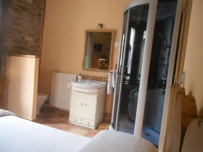 a bathroom with a sink and a toilet and a mirror at XARDÍN DE ESTRELAS *** in Sarria