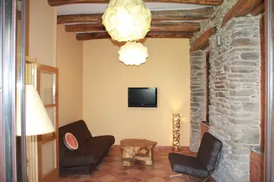 a living room with two chairs and a tv at XARDÍN DE ESTRELAS *** in Sarria