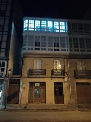 a building with blue lights on top of it at Noray Apartamentos Viveiro in Viveiro
