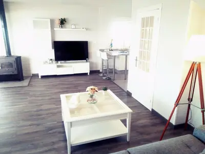 a living room with a white coffee table and a tv at Playa Catedrales Village in Barreiros