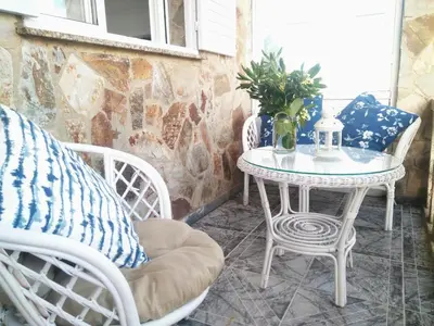 a white table and chairs on a patio at Playa Catedrales Village in Barreiros