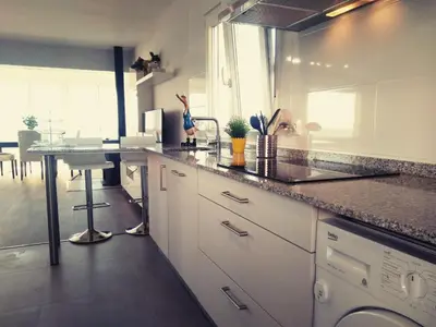 a kitchen with a counter and a table in it at Playa Catedrales Village in Barreiros