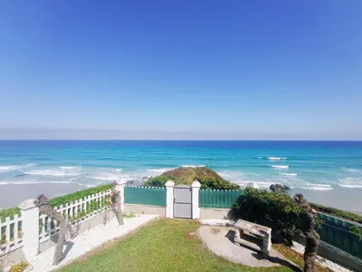 a gate to the beach with the ocean in the background at Playa Catedrales Village in Barreiros