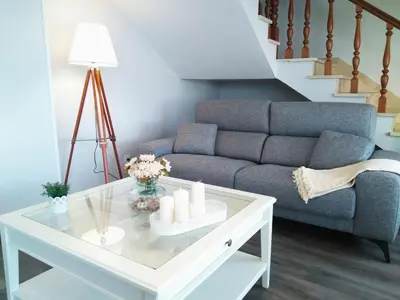 a living room with a couch and a coffee table at Playa Catedrales Village in Barreiros