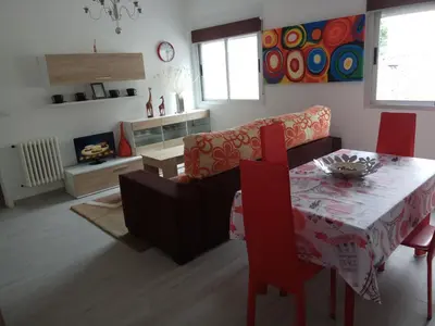 a living room with a table and a couch at APARTAMENTO EN EL CENTRO DE LALIN in Lalín