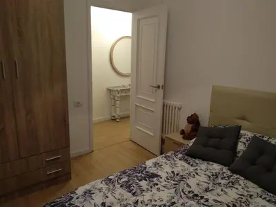 a bedroom with a bed and a dresser and a mirror at APARTAMENTO EN EL CENTRO DE LALIN in Lalín
