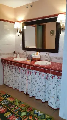 a bathroom with three sinks and a mirror at A CASA DO BUXO in Nogueira de Ramuin