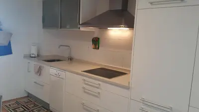 a kitchen with white cabinets and a sink at A CASA DO BUXO in Nogueira de Ramuin