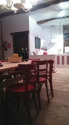 a dining room table with red chairs in a kitchen at Casa rural Nica in Arganza