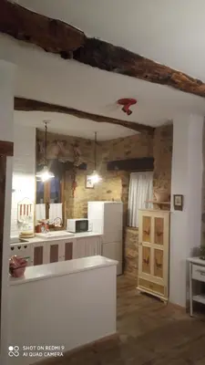 a kitchen with a white refrigerator and a counter at Casa rural Nica in Arganza