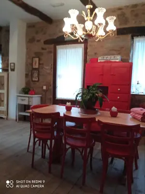 a dining room with a wooden table and red cabinets at Casa rural Nica in Arganza