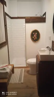 a bathroom with a toilet and a sink at Casa rural Nica in Arganza