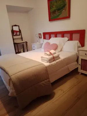 a bedroom with a bed with towels on it at Casa rural Nica in Arganza