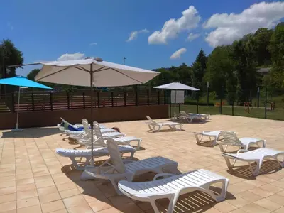a group of chairs and umbrellas on a patio at FINCA SALVADOR in Baralla