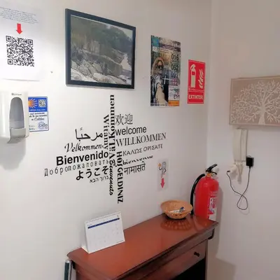 a room with a desk with writing on the wall at Pensión Fornos in Caldas de Reis