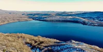 an aerial view of a large blue lake at Hotel gela in El Puente