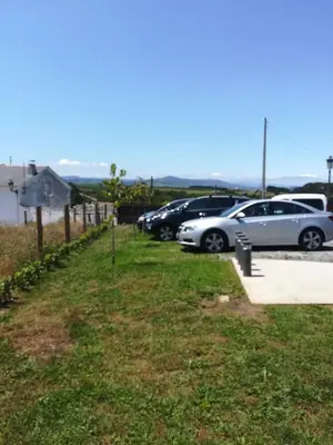 a row of parked cars in a parking lot at La Isla de Próspero in Tapia de Casariego
