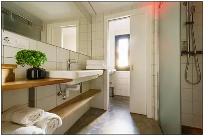 a bathroom with a sink and a shower at La Isla de Próspero in Tapia de Casariego