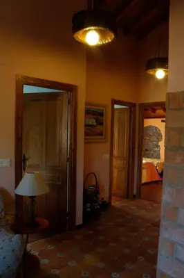 a living room with a room with a bed and a lamp at Casa el Fanoso in Luarca