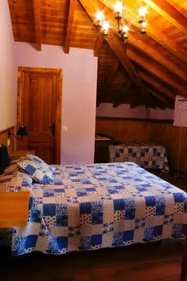 a bedroom with a blue and white quilt on a bed at Casa el Fanoso in Luarca