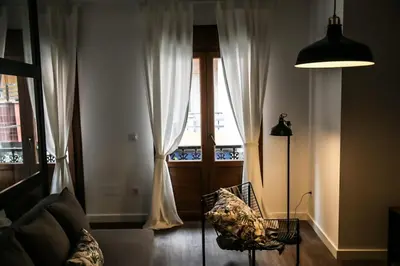 a bunch of pillows on a couch with a pillow at Apartamentos Dacosta in Ribadeo