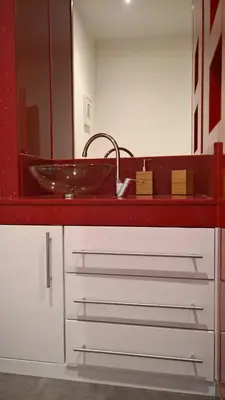 a bathroom with a sink and a red counter at Apartamento Rosaleda in Melide
