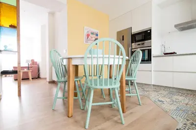 a dining room table and chairs in a kitchen at Apartamento Rosaleda in Melide