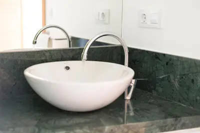 a white sink on a counter in a bathroom at Apartamento Rosaleda in Melide