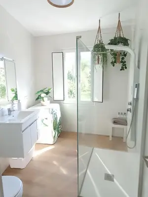 a bathroom with a glass shower and a sink at Apartamentos CASA AMELIA in Padrón