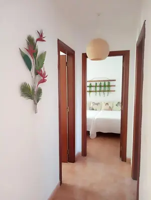 a room with a bedroom with a bed and a mirror at Apartamentos CASA AMELIA in Padrón
