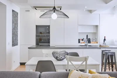 a living room and kitchen with a table and chairs at Apartamento San Pedro in Santiago de Compostela