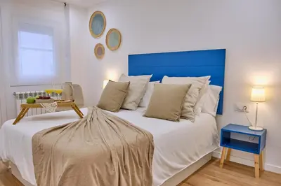 a pile of white towels sitting on a shelf at Apartamento San Pedro in Santiago de Compostela
