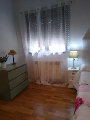 a bedroom with a bed and a dresser and a window at En plena Ribera Sacra CasaCocó in Ferreira de Panton