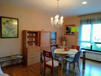 a dining room with a table and chairs and a chandelier at En plena Ribera Sacra CasaCocó in Ferreira de Panton