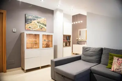 a living room with a couch and a cabinet at Apartamento Cuatro Caminos in Chantada
