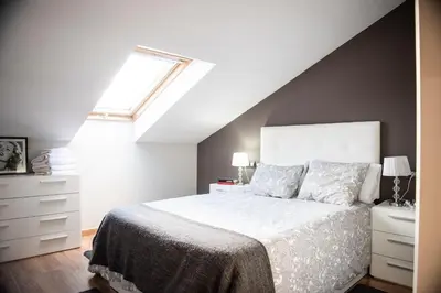 a bedroom with a white bed and a window at Apartamento Cuatro Caminos in Chantada