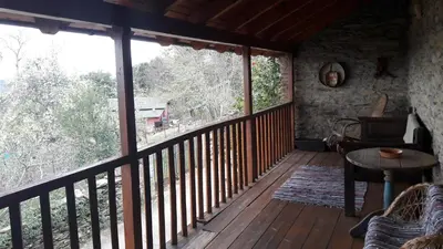 a room with a balcony with a table and a window at Casa rural Albina in Susañe del Sil