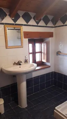 a bathroom with a sink and a window at Casa rural Albina in Susañe del Sil