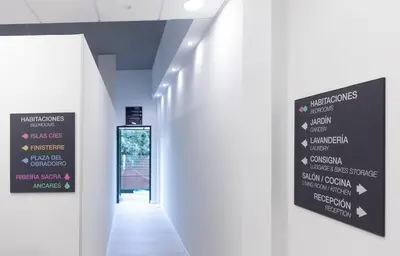 a hallway in a building with a sign on the wall at Dream in Santiago in Santiago de Compostela